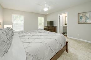 Columbus apartment for rent - A bedroom with a large bed and a television in the corner.