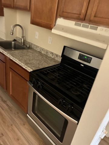 Washington apartment for rent - A modern kitchen with a stove top oven and microwave.