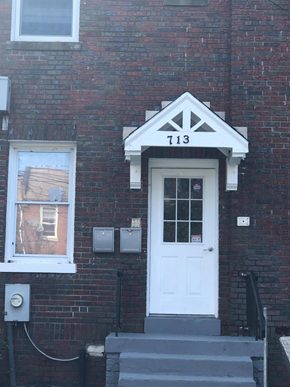 Washington apartment for rent - A white door with a black frame and a number 7113 above it.