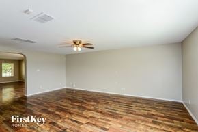 San Antonio house for rent - the spacious living room with wood flooring and a ceiling fan