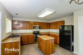 San Antonio house for rent - a kitchen with wooden cabinets and a black refrigerator