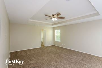 San Antonio house for rent - a living room with carpet and a ceiling fan