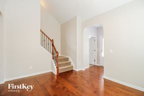 Winston-Salem house for rent - a renovated house with a staircase and a hallway with hardwood floors