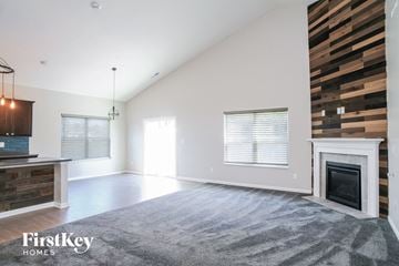 Indianapolis house for rent - a living room with a fireplace and a rug