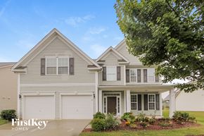 Mooresville house for rent - a white house with white shutters and a tree