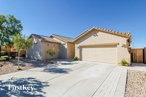 Buckeye house for rent - A house with a garage and a driveway in front of it.