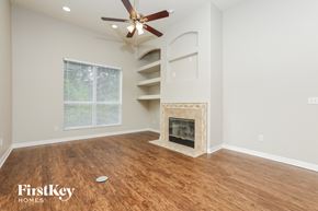 Port Orange house for rent - a living room with a fireplace and a ceiling fan