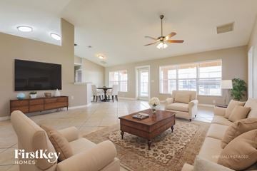 North Port house for rent - A living room with a brown coffee table and beige couches.
