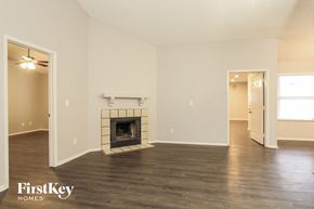 Glendale house for rent - A spacious room with a fireplace and wooden floors.
