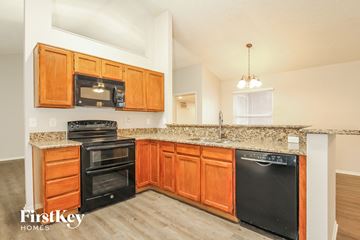 Glendale house for rent - A kitchen with wooden cabinets and black appliances.