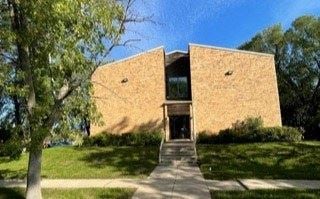 West Fargo apartment for rent - a large brick building with a tree in front of it