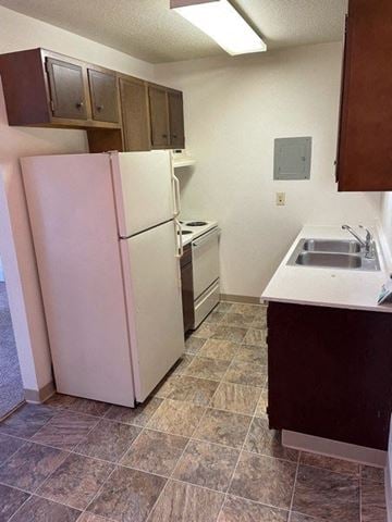 West Fargo apartment for rent - a kitchen with a white refrigerator and a sink