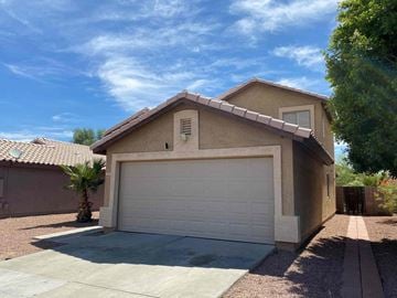 Avondale house for rent - a white garage door in front of a tan house