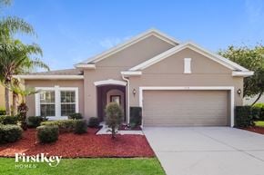 Saint Cloud house for rent - a beige house with a driveway and a garage door
