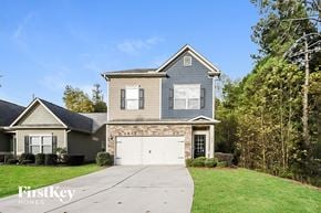 Woodstock house for rent - a house with a white garage door in front of a green yard