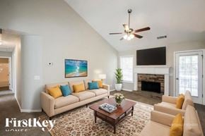 Jefferson house for rent - A living room with a beige couch, a coffee table, and a fireplace.