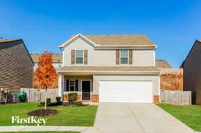 Pendergrass house for rent - a house with a white garage door and a lawn