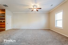 Pendergrass house for rent - a empty living room with a ceiling fan and a window