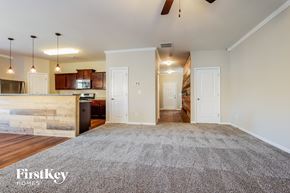 Pendergrass house for rent - an empty living room with a kitchen and a rug