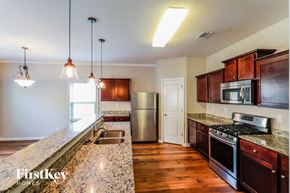 Pendergrass house for rent - a kitchen with granite counter tops and stainless steel appliances
