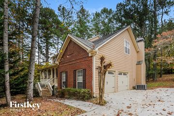 Woodstock house for rent - the front of a brick house with a garage and a driveway