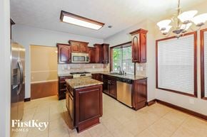 Woodstock house for rent - a kitchen with wooden cabinets and stainless steel appliances