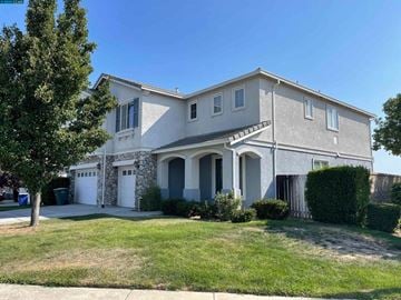 Oakley house for rent - A house with a white garage door and a stone wall.
