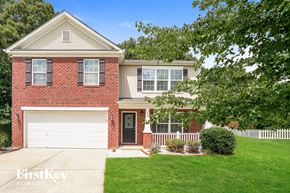 Kernersville house for rent - A brick house with a white garage door and a black door.