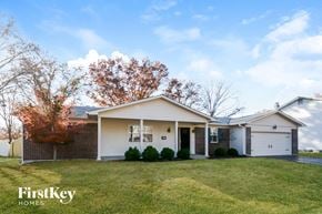 St Louis house for rent - a white and brick house with a grassy yard