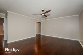 St Louis house for rent - a living room with wood floors and a ceiling fan