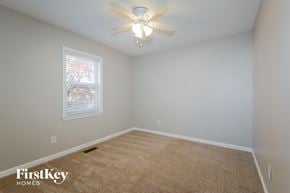 St Louis house for rent - a bedroom with a ceiling fan and a window