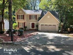 Woodstock house for rent - a house with a driveway and a garage door