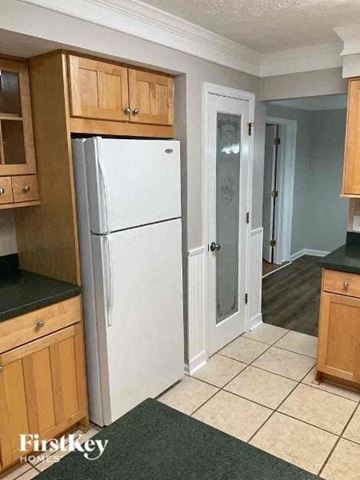 Woodstock house for rent - a kitchen with a white refrigerator and a door