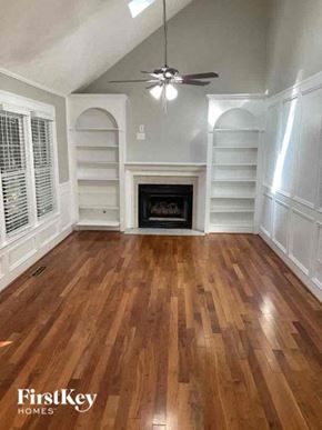 Woodstock house for rent - a living room with a hard wood floor and a fireplace