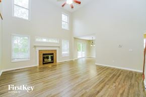 Canal Winchester house for rent - A spacious room with a fireplace and wooden flooring.
