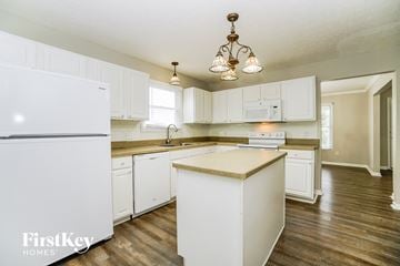 Canal Winchester house for rent - A kitchen with white cabinets and a white fridge.