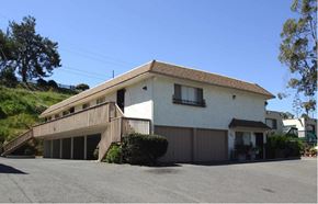 Vista apartment for rent - a white house with a balcony and a parking lot