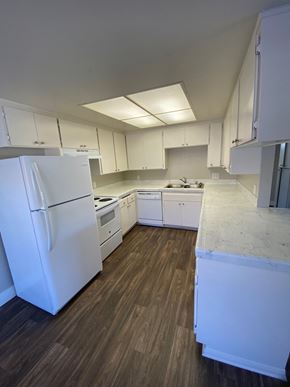 Vista apartment for rent - an empty kitchen with white appliances and white cabinets