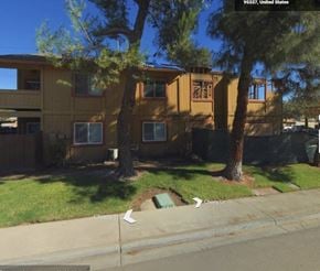 Manteca house for rent - a picture of a yellow house with trees in front of it