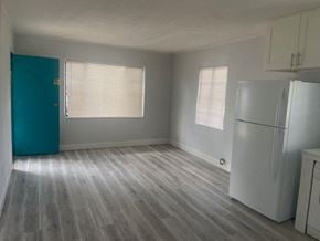 Winter Park apartment for rent - an empty room with a refrigerator and a blue door