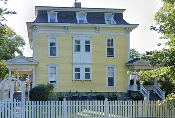 Kalamazoo apartment for rent - a yellow house with a white fence in front of it