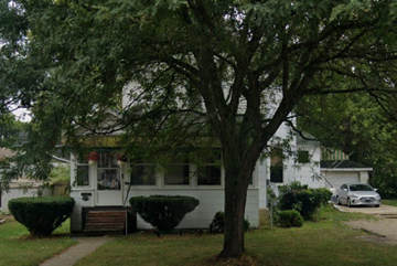 Kalamazoo apartment for rent - A white house with a tree in front of it.