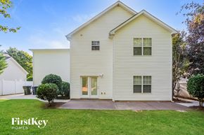 Cornelius house for rent - A two-story house with a white exterior and a small front yard.