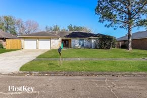 Houston house for rent - a house with a yard and a parking meter in front of it