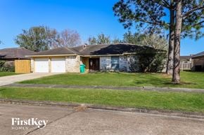 Houston house for rent - a small brick house with a lawn in front of it