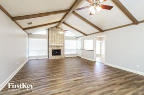 Houston house for rent - the living room with wood floors and a fireplace