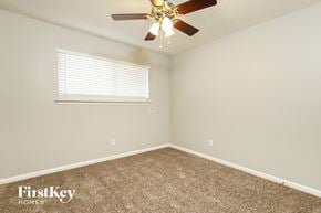 Houston house for rent - a bedroom with a ceiling fan and a window