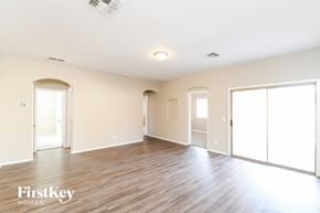 San Tan Valley house for rent - an empty living room with wood floors and white walls