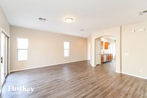 San Tan Valley house for rent - the living room and dining room of an empty house with wood flooring