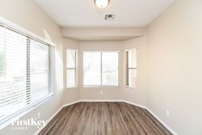 San Tan Valley house for rent - an empty living room with wood flooring and large windows